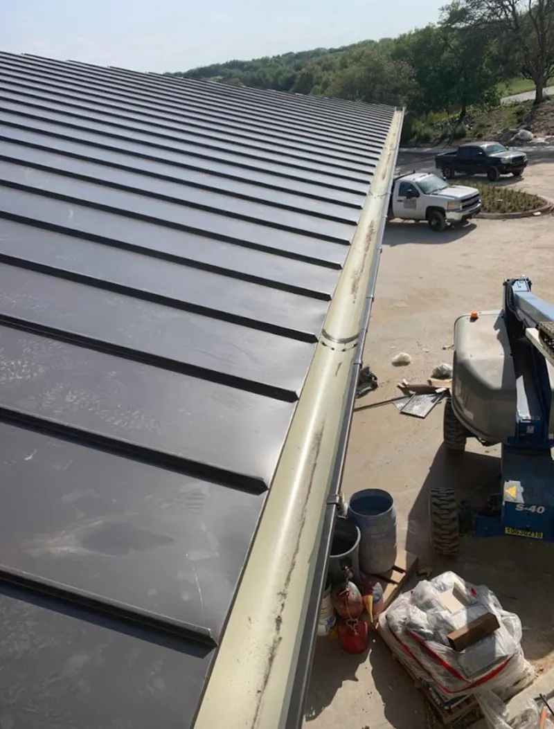Standing seam panel and gutter detail on a metal roofing jobsite in Ave Maria